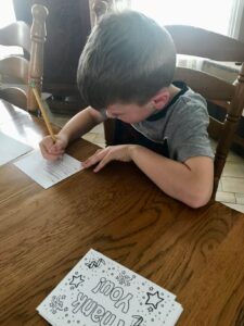 child writing thank you note